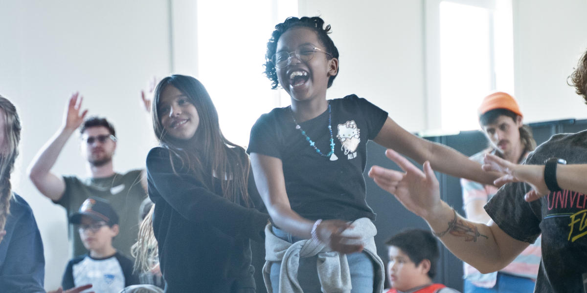 Two girls singing with actions